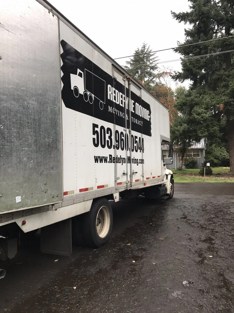 Professional Portland movers loading moving truck in downtown Portland Oregon